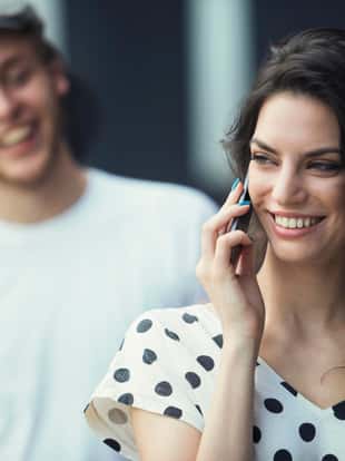 Cheerful skateboard couple on dark background
